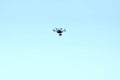 Unmanned aerial vehicle - quad copter with a camera and video transmission soars in the turquoise sky