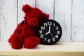 Teddy bear and alarm clock with space copy on wooden background Royalty Free Stock Photo