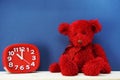 Teddy bear and alarm clock with space copy on wooden background Royalty Free Stock Photo