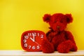 Teddy bear and alarm clock with space copy on wooden background Royalty Free Stock Photo