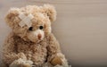 Teddy bear with bandage on a wooden floor