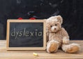 Teddy bear and a blackboard. Dyslexia text drawing on the blackboard Royalty Free Stock Photo