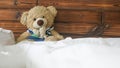 teddy bear in blue shirt on a bed Royalty Free Stock Photo