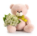 Teddy bear with a bouquet of lovely fresh lilies of the valley isolated. Concept for congratulations in advertising and social