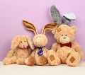 Teddy bear in a cap and a cute teddy hare with long ears, a red butterfly tied around his neck