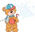 Teddy bear with cap and scarf blowing soap bubbles Royalty Free Stock Photo
