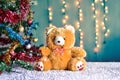 Teddy Bear in Christmas and Multi colored balls on christmas tree Royalty Free Stock Photo