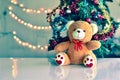 Teddy Bear in Christmas and Multi colored balls on christmas tree Royalty Free Stock Photo