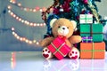 Teddy Bear in Christmas and Multi colored balls on christmas tree Royalty Free Stock Photo