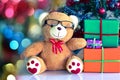 Teddy Bear in Christmas and Multi colored balls on christmas tree Royalty Free Stock Photo