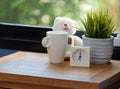 A teddy bear,coffee cup and white alarm on wood table in blue bedroom Royalty Free Stock Photo