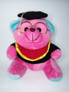 Pink teddy bear wearing a graduation gown and glasses on a white background Royalty Free Stock Photo