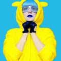 Teddy bear crazy girl in a bright hoodie on a blue background co Royalty Free Stock Photo