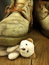 Teddy bear crushed by a heavy, old military boot.