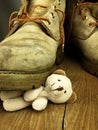 Teddy bear crushed by a heavy, old military boot.