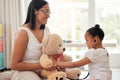 Teddy bear doctor, girl game and mother with smile for child, happy medical work and family love for healthcare in home Royalty Free Stock Photo