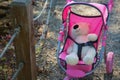 Teddy bear fastened in the baby carriage Royalty Free Stock Photo