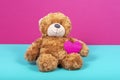 Teddy bear with felt heart on two color background Royalty Free Stock Photo