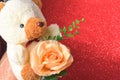 Teddy bear with flowers in valentines day on red glitter bokeh lights Blurred abstract background Royalty Free Stock Photo