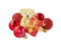 Teddy bear with gift and red Christmas balls on white. Royalty Free Stock Photo