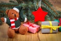 Teddy bear with gifts for Christmas, spruce branches and red star Royalty Free Stock Photo