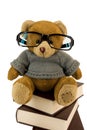Teddy bear, glasses and pile of old books