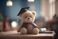 Teddy bear with graduation cap and diploma on table in classroom. Education concept Royalty Free Stock Photo