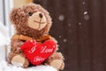 A teddy bear with a heart on the window. The inscription I love you Royalty Free Stock Photo