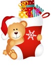 Teddy bear holding Christmas stocking with gifts Royalty Free Stock Photo