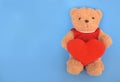 Teddy Bear Holding A Heart Shaped Pillow On Blue Background. Valentines Day. Love Heart. Vintage Retro Romantic Style. Unusual Cre