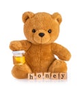 Teddy bear holding honey pot isolated white background Royalty Free Stock Photo