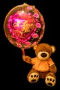 Teddy Bear holding red heart-shaped balloon. Valentine bear with Royalty Free Stock Photo