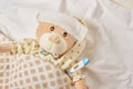 Teddy bear lying sick in bed with with thermometer Royalty Free Stock Photo