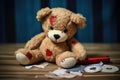 a teddy bear mended with patches and threads