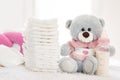 Teddy bear with nappies and bottle with milk
