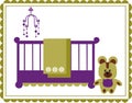 Teddy bear next to baby cradle and mobile