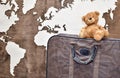 teddy bear on an old leather suitcase on a wooden background Royalty Free Stock Photo