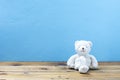 Teddy bear on old wood ,blue wall background Royalty Free Stock Photo