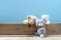 Teddy bear on old wood ,blue wall background Royalty Free Stock Photo