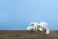 teddy bear on old wood ,blue wall background. Royalty Free Stock Photo