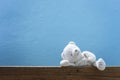 teddy bear on old wood ,blue wall background. Royalty Free Stock Photo