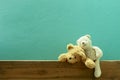 Teddy bear on old wood in front green wall background Royalty Free Stock Photo