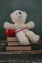 Teddy bear, pencil and apple on stack of books Royalty Free Stock Photo