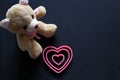 Teddy bear and pink hearts on black background, Valentine`s Day gifts, advertising banner Royalty Free Stock Photo