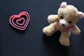 Teddy bear and pink hearts on black background, Valentine`s Day gifts, advertising banner Royalty Free Stock Photo