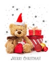 Teddy bear in a red cap and boxes with gifts on a background with stars Royalty Free Stock Photo