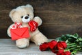 Teddy bear, red roses and red envelope Royalty Free Stock Photo