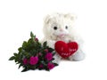 Teddy bear, red velvet heart and bouquet of roses