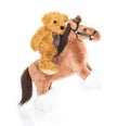 Teddy bear riding a horse Royalty Free Stock Photo