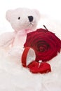 Teddy bear with ring and red rose